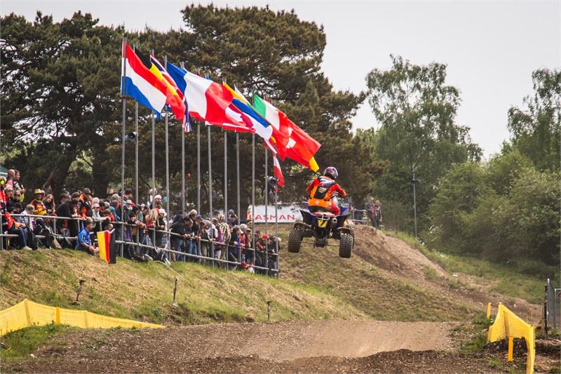 Harry in front of flags World Quad Championship R4
